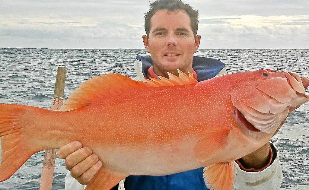Chris is proud of his catch. Chris is proud of his catch.